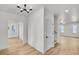 Bright entryway featuring hardwood floors, white walls, and modern lighting at 474 Maxwell Rd, Roswell, GA 30075