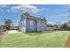 Rear exterior view of the home displaying a blue facade, garage, and manicured lawn at 474 Maxwell Rd, Roswell, GA 30075