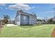Blue two-story home with lush front lawn, freshly installed landscaping, and a long driveway at 474 Maxwell Rd, Roswell, GA 30075
