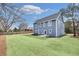 View of the rear exterior featuring fresh sod, landscaping, and blue siding at 474 Maxwell Rd, Roswell, GA 30075