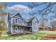 Charming blue two-story home featuring a covered porch and landscaped yard at 474 Maxwell Rd, Roswell, GA 30075