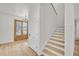 Foyer with light hardwood floors, staircase, and double wood-framed glass doors at 474 Maxwell Rd, Roswell, GA 30075