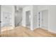 Hallway featuring hardwood floors, multiple doorways, and natural light at 474 Maxwell Rd, Roswell, GA 30075