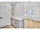 Hallway featuring built-in cabinets and drawers with floating shelves, offering ample storage space at 474 Maxwell Rd, Roswell, GA 30075