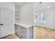 Hallway with gray cabinets, white countertop, shelving, and light wood floors at 474 Maxwell Rd, Roswell, GA 30075