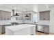 A stylish kitchen featuring gray cabinetry, a quartz countertop island, and modern pendant lighting at 474 Maxwell Rd, Roswell, GA 30075