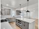 Modern kitchen with a white island, gray cabinets, stainless steel appliances, and bright white tile backsplash at 474 Maxwell Rd, Roswell, GA 30075