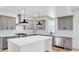 Modern kitchen with a white island, gray cabinets, stainless steel appliances, and bright white tile backsplash at 474 Maxwell Rd, Roswell, GA 30075
