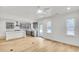 Bright, open-concept kitchen with hardwood floors and view of the adjacent living space and stainless steel appliances at 474 Maxwell Rd, Roswell, GA 30075