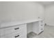 Laundry room features a quartz countertop, white cabinets with modern hardware, and tile flooring at 474 Maxwell Rd, Roswell, GA 30075