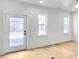 Living room with neutral paint, modern light fixture, and access to rear entrance at 474 Maxwell Rd, Roswell, GA 30075