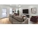 Living room with neutral paint, modern light fixture, and access to rear entrance at 474 Maxwell Rd, Roswell, GA 30075