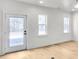 Clean and bright living room showing windows and a glass door for lots of natural light at 474 Maxwell Rd, Roswell, GA 30075