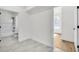 A bright, empty room featuring gray tile flooring and entrances to other rooms at 474 Maxwell Rd, Roswell, GA 30075