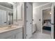 Bright bathroom with modern fixtures, double vanity, and a doorway leading into the main bedroom at 1290 Regency Center Sw Dr, Atlanta, GA 30331