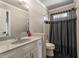 Bathroom features a vanity, faucet, and combined tub and shower with a curtain at 1290 Regency Center Sw Dr, Atlanta, GA 30331