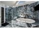 A modern bathroom showcasing a standalone tub, a frameless glass shower, and striking tile work at 1290 Regency Center Sw Dr, Atlanta, GA 30331