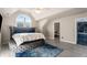 Primary bedroom featuring a platform bed and a unique arched window, and doorway to bathroom at 1290 Regency Center Sw Dr, Atlanta, GA 30331