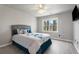 Bedroom featuring a large window, ceiling fan, and a comfortable-looking bed with decorative pillows at 1290 Regency Center Sw Dr, Atlanta, GA 30331