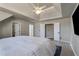 Spacious bedroom with multiple doors and a ceiling fan with adjacent doors to bathroom and closet at 1290 Regency Center Sw Dr, Atlanta, GA 30331