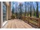 Wooden deck with railing, offering views of the surrounding trees and natural landscape at 1290 Regency Center Sw Dr, Atlanta, GA 30331