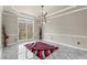 Bright dining room featuring a modern chandelier, beautiful marble floors, and large window at 1290 Regency Center Sw Dr, Atlanta, GA 30331