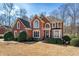 Classic brick home with mature trees and manicured shrubs in the front yard at 1290 Regency Center Sw Dr, Atlanta, GA 30331