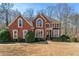 Charming brick home with a well-manicured front lawn and mature landscaping at 1290 Regency Center Sw Dr, Atlanta, GA 30331