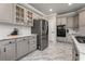 Kitchen boasts updated stainless appliances, stone countertops, and grey custom cabinets at 1290 Regency Center Sw Dr, Atlanta, GA 30331