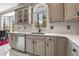 Kitchen sink with quartz countertop, stainless steel dishwasher, and view to the yard at 1290 Regency Center Sw Dr, Atlanta, GA 30331