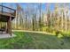 Backyard patio view of the spacious lawn extending into the natural wooded landscape at 1290 Regency Center Sw Dr, Atlanta, GA 30331