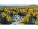 A sprawling home is nestled amidst lush greenery, offering stunning views and privacy at 1806 Wynthrop Manor Sw Dr, Marietta, GA 30064