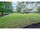 Expansive lawn with mulch and trees in a beautiful backyard setting at 1806 Wynthrop Manor Sw Dr, Marietta, GA 30064