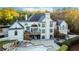 A spacious backyard with a tiered deck, covered seating area, and a luxurious pool at 1806 Wynthrop Manor Sw Dr, Marietta, GA 30064