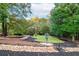 Beautiful backyard with well-maintained landscaping and a small bridge over stones at 1806 Wynthrop Manor Sw Dr, Marietta, GA 30064