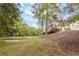 Spacious backyard on a hill surrounded by trees with a sand pit at 1806 Wynthrop Manor Sw Dr, Marietta, GA 30064