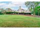 A spacious home with large windows and manicured hedges on a lush green lawn at 1806 Wynthrop Manor Sw Dr, Marietta, GA 30064