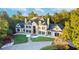 A grand home featuring a symmetrical facade, dormer windows, and lush landscaping around the circular driveway at 1806 Wynthrop Manor Sw Dr, Marietta, GA 30064