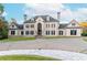 Beautifully designed home with a spacious front yard, circular driveway, and well-manicured landscaping at 1806 Wynthrop Manor Sw Dr, Marietta, GA 30064