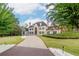 Stately home with a long driveway, lush lawn, and mature trees creating a serene and private setting at 1806 Wynthrop Manor Sw Dr, Marietta, GA 30064