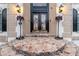 Detailed stone steps lead to a grand entrance with decorative sconces and ornate flower displays at 1806 Wynthrop Manor Sw Dr, Marietta, GA 30064