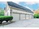 Attached four-car garage with carriage-style doors and exterior lighting, offering ample parking and convenience at 1806 Wynthrop Manor Sw Dr, Marietta, GA 30064