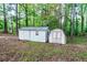 Two storage sheds situated in a wooded area with some greenery at 1806 Wynthrop Manor Sw Dr, Marietta, GA 30064