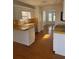 Bright kitchen with white cabinets, wooden floors and yellow countertops at 4155 Gables Pl, Buford, GA 30519