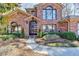 Charming brick home with a meticulously landscaped front yard and a beautiful arched entryway at 5180 Cameron Forest Pkwy, Johns Creek, GA 30022