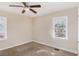 Neutral bedroom with a ceiling fan, carpet flooring, and a window with natural light at 2867 Mitchell Dr, Decatur, GA 30032