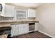Modern kitchen with granite countertops, stainless steel appliances, and white cabinets at 2867 Mitchell Dr, Decatur, GA 30032
