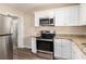 Well-equipped kitchen boasts stainless steel appliances, granite counters, and ample storage at 2867 Mitchell Dr, Decatur, GA 30032