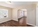 Open-concept living room with hardwood floors, large window, and charming archway at 2867 Mitchell Dr, Decatur, GA 30032
