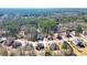 An aerial shot showcases a home surrounded by a lush forest and other beautiful residences at 6026 Southland Dr, Stone Mountain, GA 30087